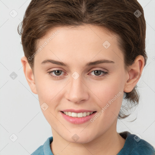 Joyful white young-adult female with short  brown hair and grey eyes