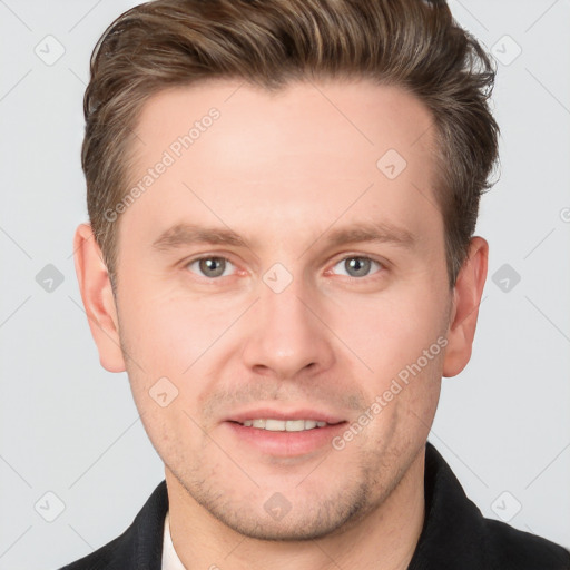 Joyful white young-adult male with short  brown hair and grey eyes