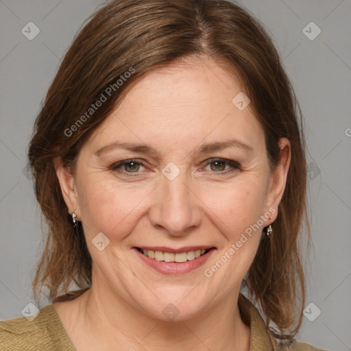 Joyful white adult female with medium  brown hair and grey eyes