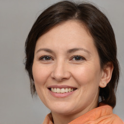 Joyful white adult female with medium  brown hair and brown eyes