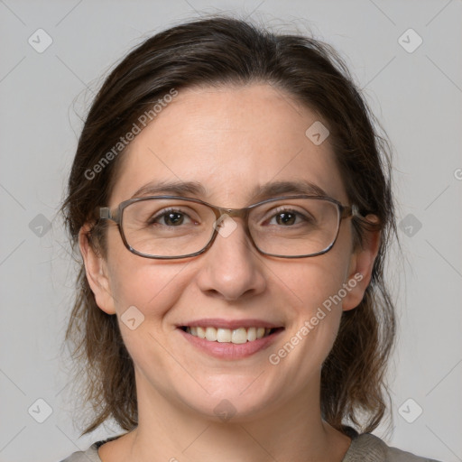 Joyful white adult female with medium  brown hair and grey eyes