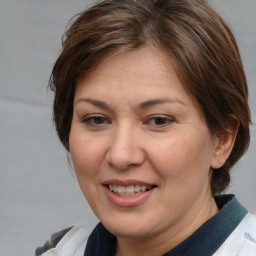 Joyful white adult female with medium  brown hair and brown eyes