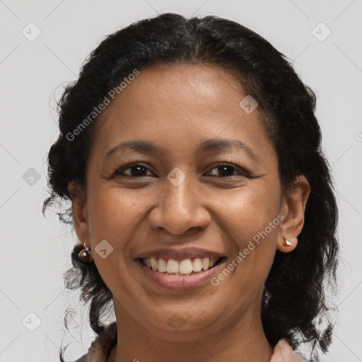 Joyful black adult female with medium  brown hair and brown eyes