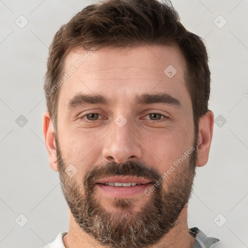 Joyful white young-adult male with short  brown hair and brown eyes