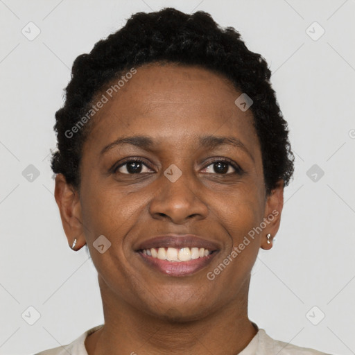 Joyful black adult female with short  brown hair and brown eyes