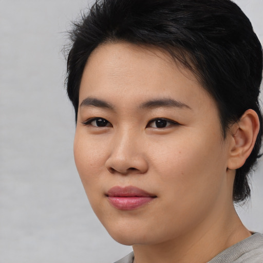 Joyful asian young-adult female with medium  black hair and brown eyes