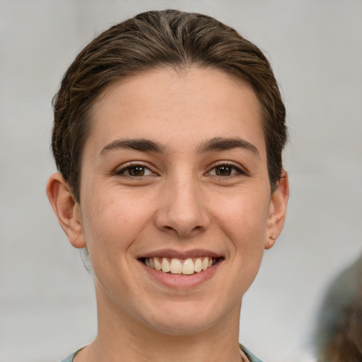 Joyful white young-adult female with short  brown hair and brown eyes