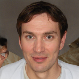 Joyful white adult male with short  brown hair and brown eyes