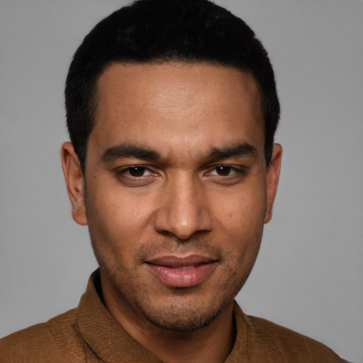 Joyful white young-adult male with short  black hair and brown eyes