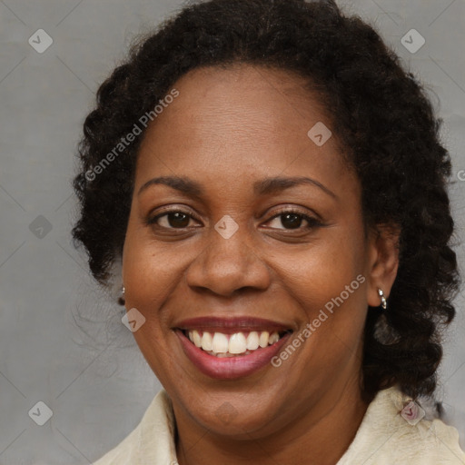 Joyful black adult female with long  brown hair and brown eyes