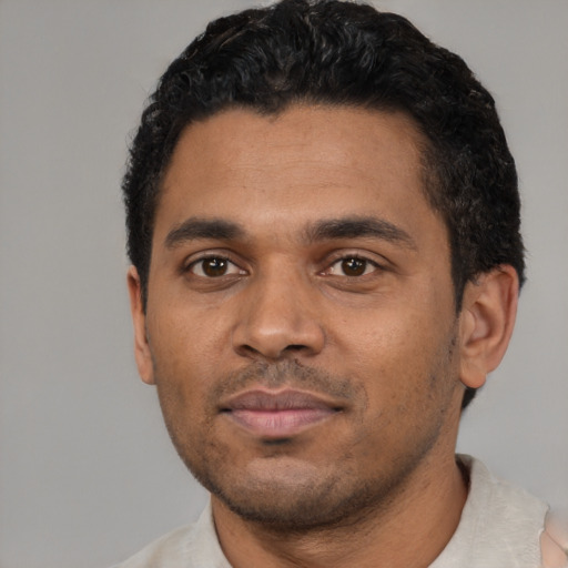 Neutral black young-adult male with short  black hair and brown eyes