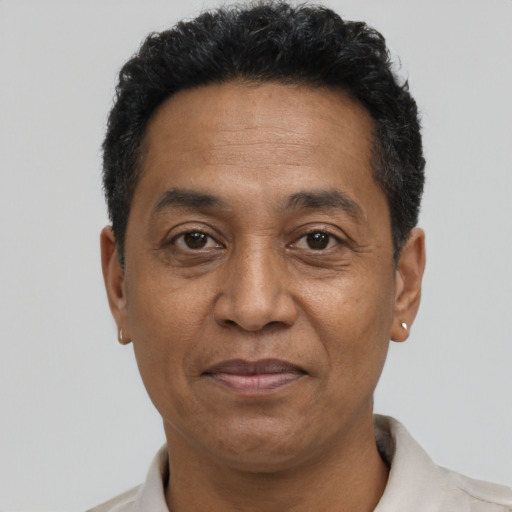 Joyful black adult male with short  black hair and brown eyes
