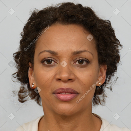 Joyful black adult female with medium  brown hair and brown eyes