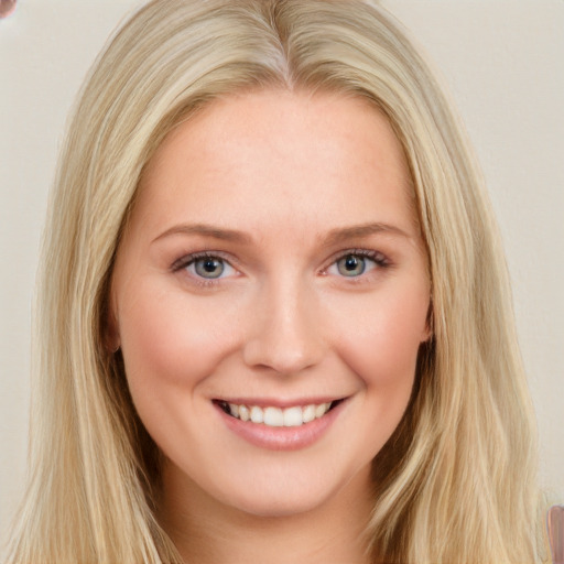 Joyful white young-adult female with long  brown hair and blue eyes