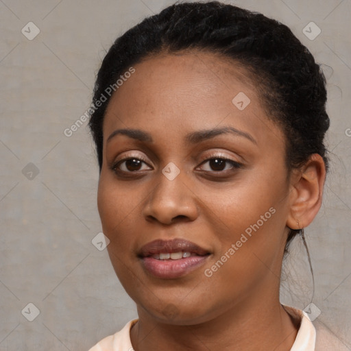 Joyful black young-adult female with short  black hair and brown eyes