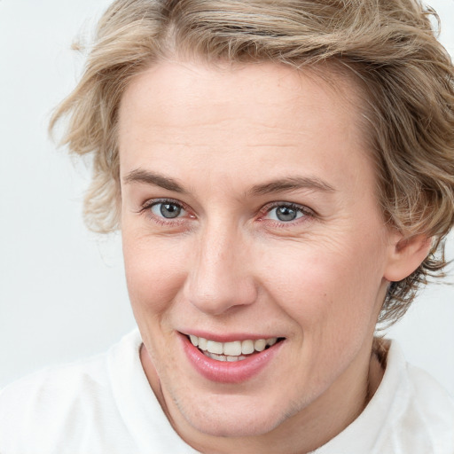 Joyful white young-adult female with medium  brown hair and blue eyes