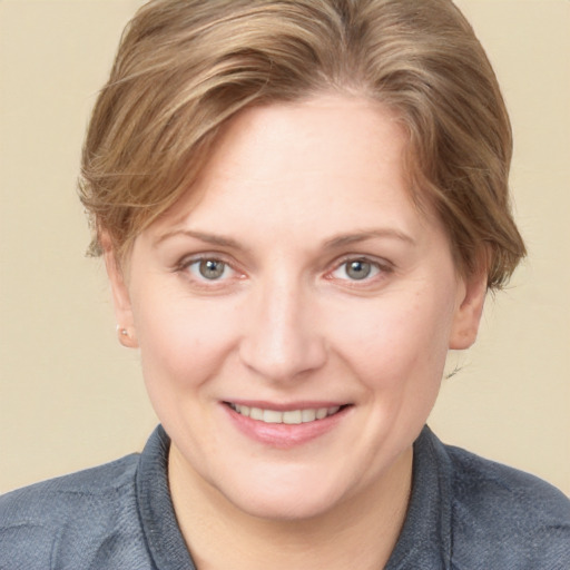 Joyful white young-adult female with short  brown hair and grey eyes