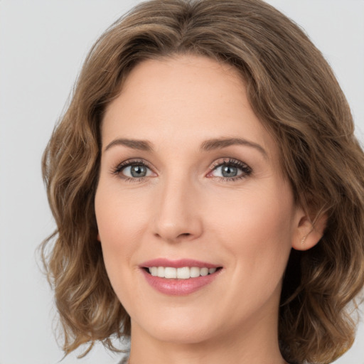 Joyful white young-adult female with medium  brown hair and green eyes