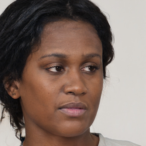 Neutral black young-adult female with medium  brown hair and brown eyes