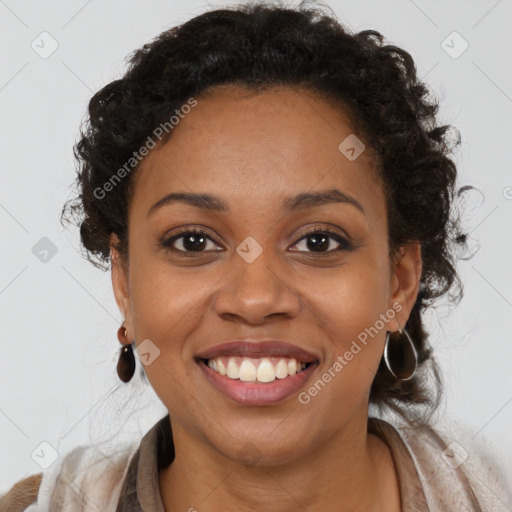 Joyful black young-adult female with long  brown hair and brown eyes