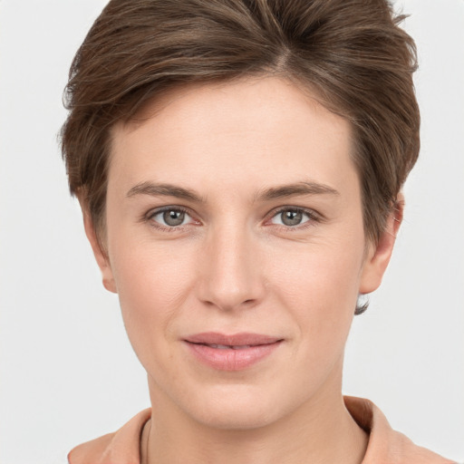 Joyful white young-adult female with short  brown hair and grey eyes