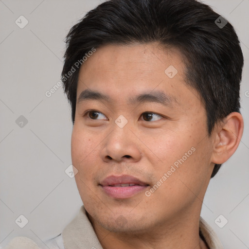 Joyful asian young-adult male with short  brown hair and brown eyes