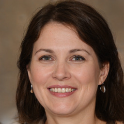 Joyful white adult female with medium  brown hair and brown eyes