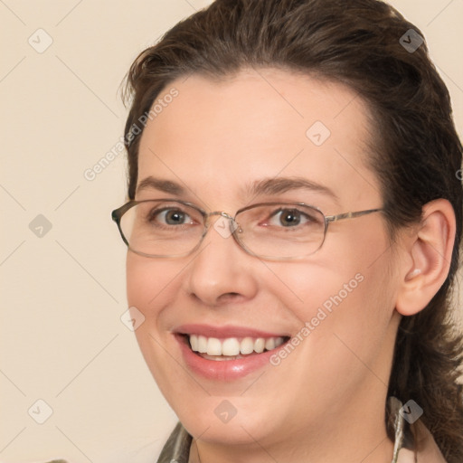 Joyful white adult female with medium  brown hair and brown eyes