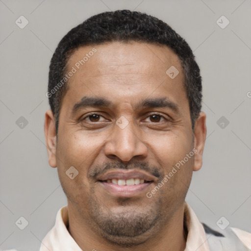 Joyful latino adult male with short  black hair and brown eyes
