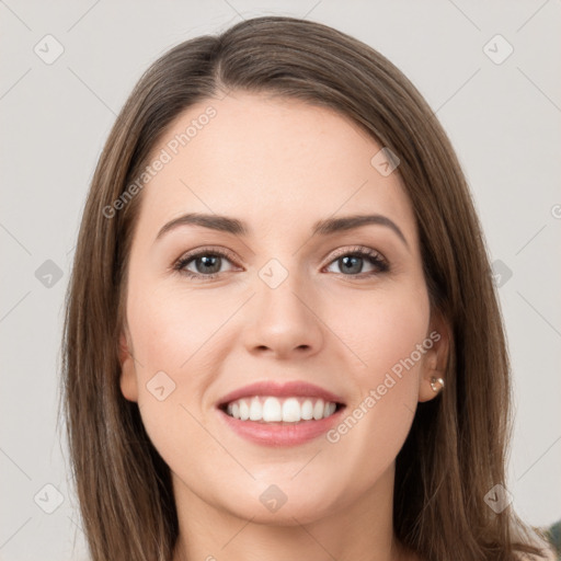 Joyful white young-adult female with long  brown hair and grey eyes