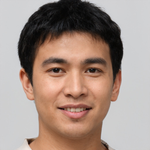 Joyful asian young-adult male with short  brown hair and brown eyes