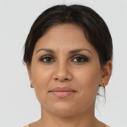 Joyful latino young-adult female with short  brown hair and brown eyes