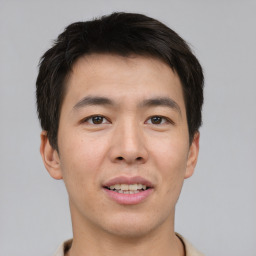 Joyful asian young-adult male with short  brown hair and brown eyes