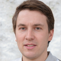 Joyful white adult male with short  brown hair and grey eyes