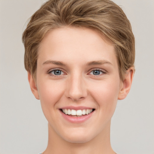 Joyful white young-adult female with short  brown hair and grey eyes