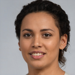 Joyful latino young-adult female with short  brown hair and brown eyes