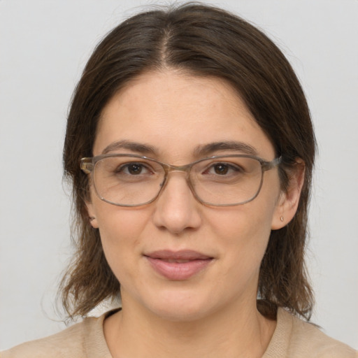 Joyful white adult female with medium  brown hair and brown eyes