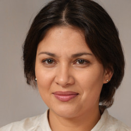 Joyful white adult female with medium  brown hair and brown eyes