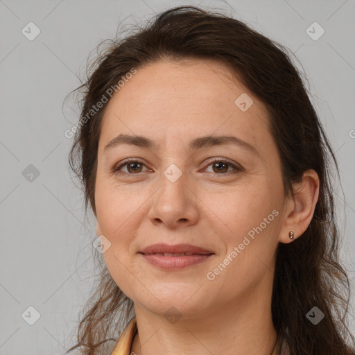 Joyful white adult female with long  brown hair and brown eyes