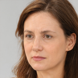 Joyful white adult female with long  brown hair and brown eyes