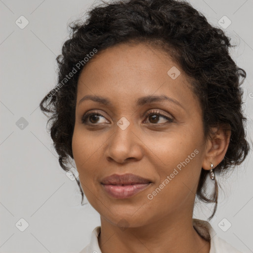 Joyful black adult female with medium  brown hair and brown eyes