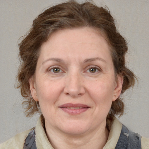 Joyful white adult female with medium  brown hair and blue eyes