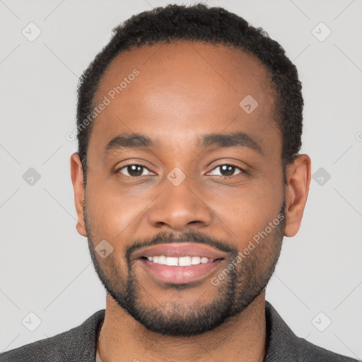 Joyful black young-adult male with short  black hair and brown eyes