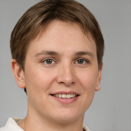 Joyful white young-adult female with short  brown hair and grey eyes