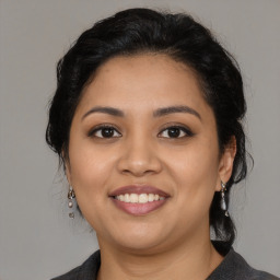 Joyful latino young-adult female with medium  black hair and brown eyes