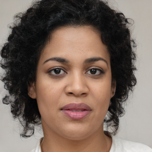 Joyful black young-adult female with medium  brown hair and brown eyes