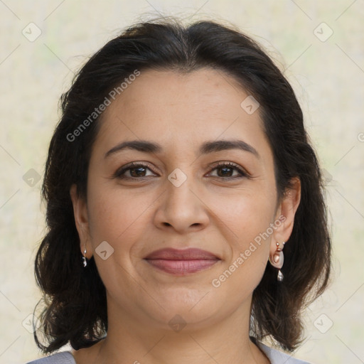 Joyful latino adult female with medium  brown hair and brown eyes