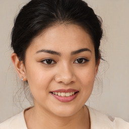 Joyful latino young-adult female with medium  brown hair and brown eyes