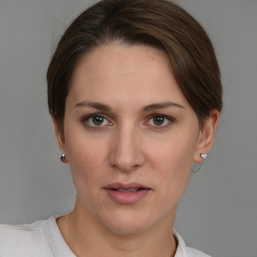 Joyful white young-adult female with short  brown hair and grey eyes