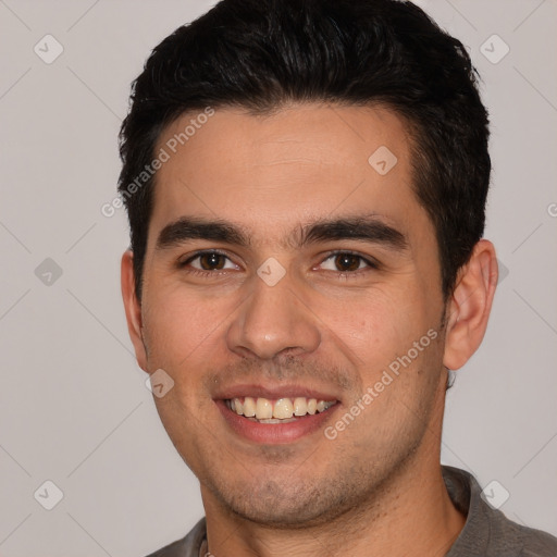 Joyful white young-adult male with short  black hair and brown eyes